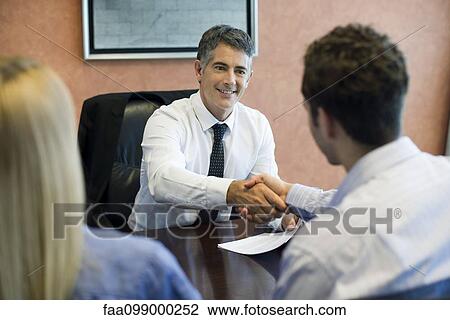 Young couple meeting with financial advisor View Large Photo Image Stock Image - Young couple meeting with financial advisor. Fotosearch