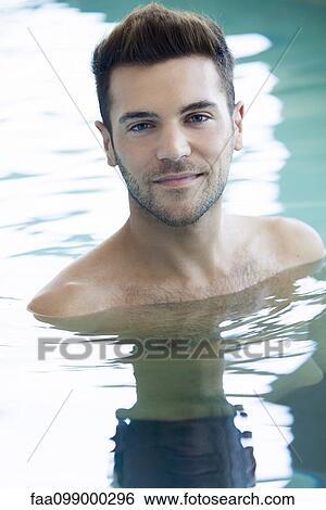 Stock Photograph - Young man in swimming pool. Fotosearch