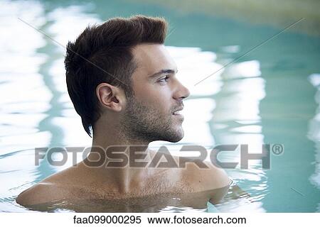 Stock Photography - Young man relaxing in pool. Fotosearch