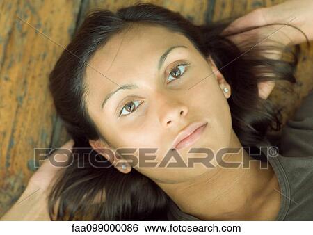 Young woman lying on floor, portrait View Large Photo Image Stock Photograph - Young woman lying on floor, portrait. Fotosearch