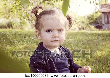 Stock Photograph - Baby girl outdoors, portrait. Fotosearch