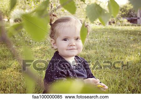 Stock Photography - Baby girl outdoors, portrait. Fotosearch