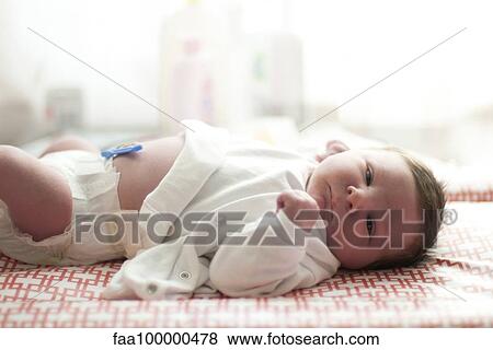 Stock Photo - Baby lying on changing table. Fotosearch