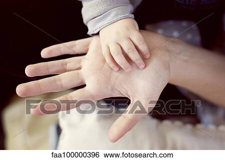 Baby's hand touching adult's hand View Large Photo Image Stock Photograph - Baby's hand touching adult's hand. Fotosearch