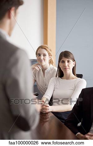 Business professionals attending presentation View Large Photo Image Stock Photograph - Business professionals attending presentation. Fotosearch