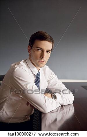 Businessman sitting in office, portrait View Large Photo Image Stock Photo - Businessman sitting in office, portrait. Fotosearch