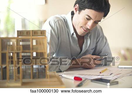 Businessman working at desk View Large Photo Image Stock Image - Businessman working at desk. Fotosearch
