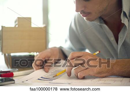 Businessman working on paperwork View Large Photo Image Stock Photo - Businessman working on paperwork. Fotosearch