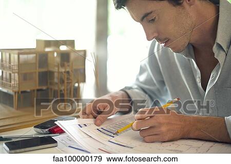 Businessman working on paperwork View Large Photo Image Stock Photo - Businessman working on paperwork. Fotosearch