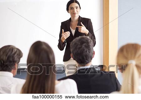 Businesswoman giving presentation at meeting View Large Photo Image Stock Photography - Businesswoman giving presentation at meeting. Fotosearch
