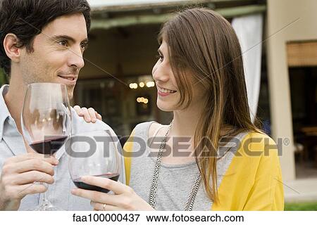 Couple clinking wine glasses View Large Photo Image Stock Photo - Couple clinking wine glasses. Fotosearch