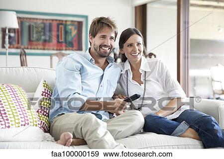 Stock Photo - Couple watching TV together. Fotosearch