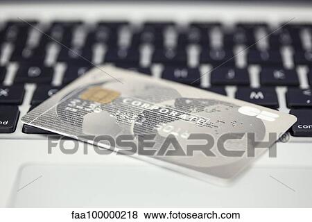 Credit card resting on computer keyboard View Large Photo Image Stock Photo - Credit card resting on computer keyboard. Fotosearch