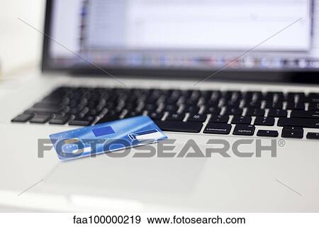 Credit card resting on laptop computer View Large Photo Image Stock Photo - Credit card resting on laptop computer. Fotosearch