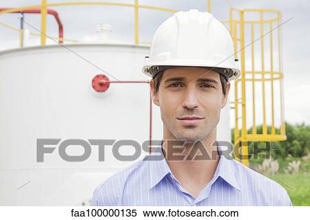 Stock Photography - Engineer at industrial site, portrait. Fotosearch