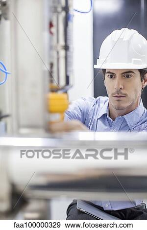 Engineer at work at industrial plant View Large Photo Image Stock Photo - Engineer at work at industrial plant. Fotosearch