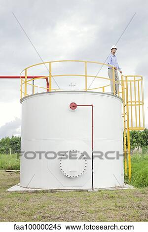 Engineer inspecting chemical storage tank View Large Photo Image Stock Photography - Engineer inspecting chemical storage tank. Fotosearch