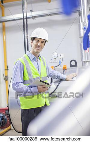 Engineer working in industrial plant, portrait View Large Photo Image Stock Photograph - Engineer working in industrial plant, portrait. Fotosearch