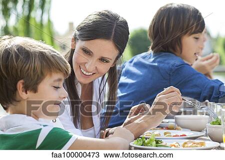 Family enjoying healthy meal outdoors View Large Photo Image Stock Image - Family enjoying healthy meal outdoors. Fotosearch