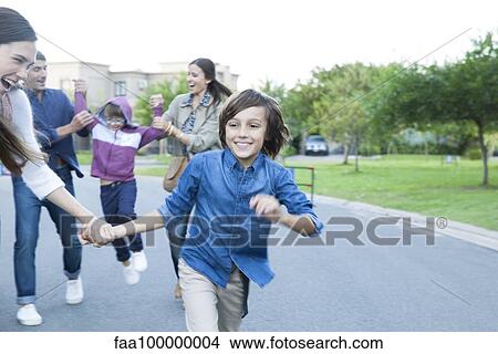 Picture - Family playing together outdoors. Fotosearch