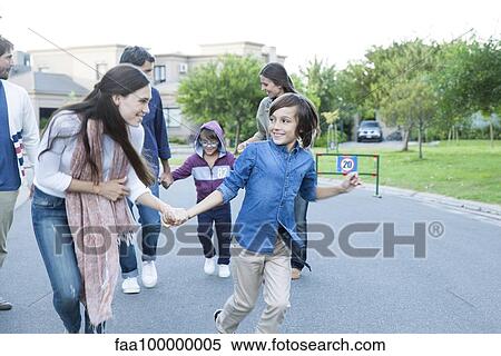 Stock Photography - Family playing together outdoors. Fotosearch