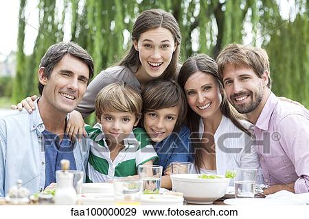 Stock Photo - Family posing for portrait at outdoor gathering. Fotosearch