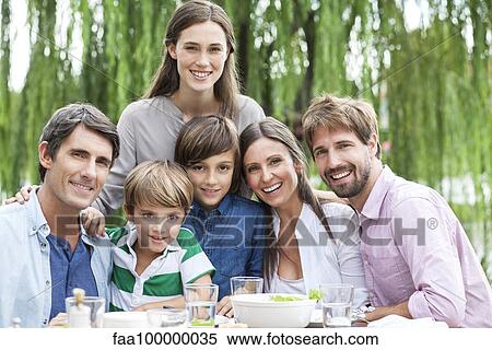 Family posing for portrait at outdoor gathering View Large Photo Image Stock Photography - Family posing for portrait at outdoor gathering. Fotosearch
