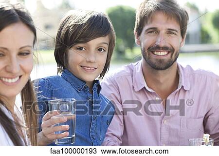 Family relaxing together outdoors View Large Photo Image Stock Image - Family relaxing together outdoors. Fotosearch