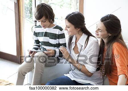 Family using digital tablet together View Large Photo Image Stock Image - Family using digital tablet together. Fotosearch