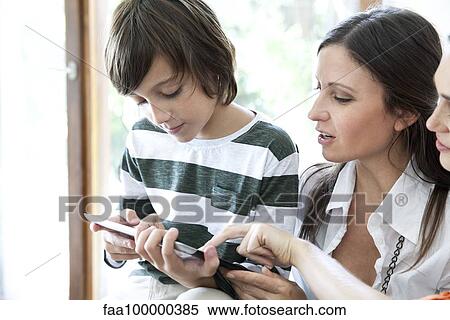 Stock Photography - Family using digital tablet together. Fotosearch