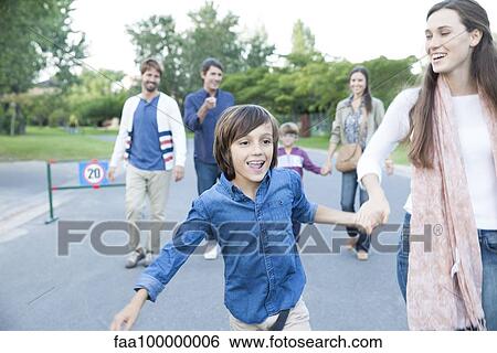 Stock Photograph - Family walking together outdoors. Fotosearch