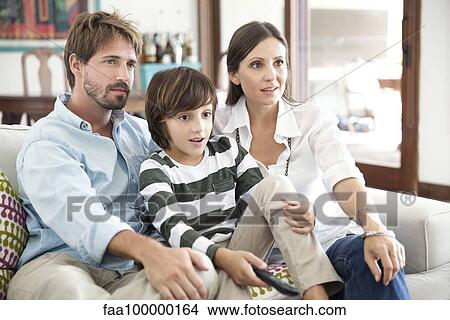 Family watching TV together View Large Photo Image Picture - Family watching TV together. Fotosearch