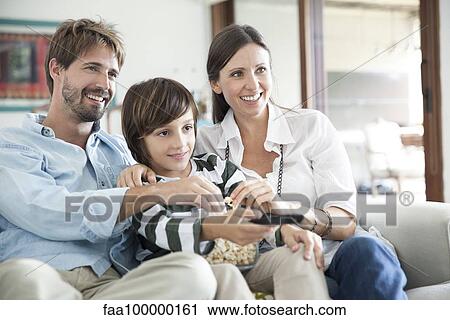 Family watching TV together View Large Photo Image Stock Image - Family watching TV together. Fotosearch