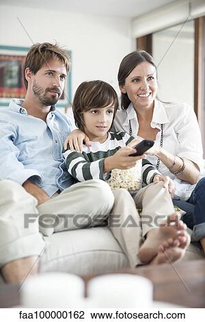 Stock Image - Family watching TV together. Fotosearch