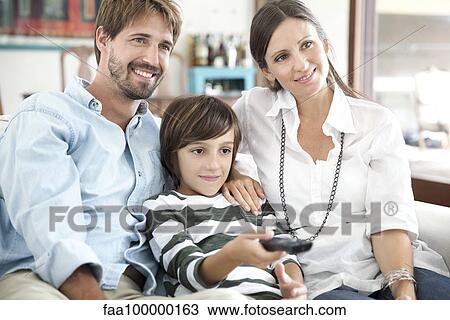 Stock Image - Family watching TV together. Fotosearch