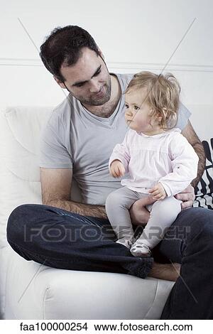 Father holding baby girl on lap View Large Photo Image Picture - Father holding baby girl on lap. Fotosearch