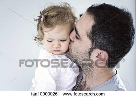 Father kissing baby girl's cheek View Large Photo Image Stock Image - Father kissing baby girl's cheek. Fotosearch