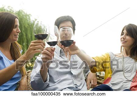 Stock Photography - Friends clinking wine glasses. Fotosearch