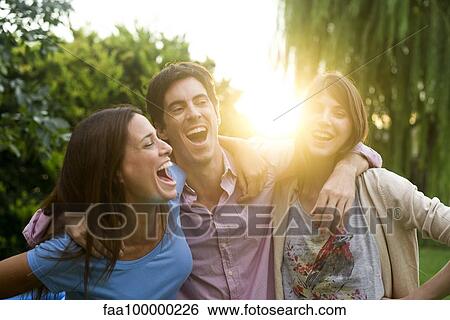Friends enjoying weekend get together outdoors View Large Photo Image Stock Photograph - Friends enjoying weekend get together outdoors. Fotosearch