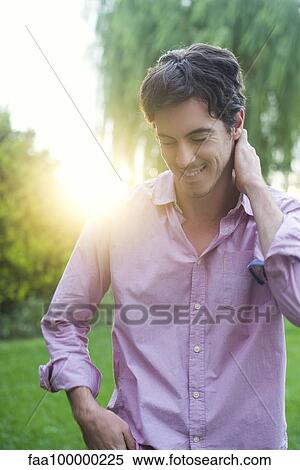 Man enjoying moment of self reflection during walk through park View Large Photo Image Stock Photography - Man enjoying moment of self reflection during walk through park. Fotosearch