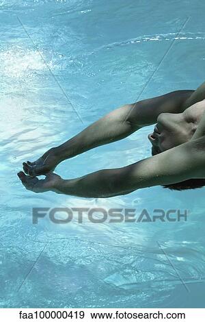 Stock Photo - Man leaning backward over pool, arms raised. Fotosearch