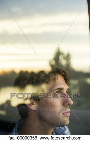 Stock Photo - Man looking at view with melancholic air. Fotosearch