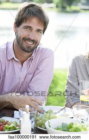 Man relaxing at picnic View Large Photo Image Stock Image - Man relaxing at picnic. Fotosearch