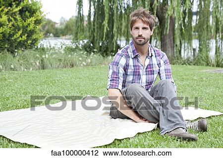 Man sitting on blanket outdoors View Large Photo Image Stock Image - Man sitting on blanket outdoors. Fotosearch