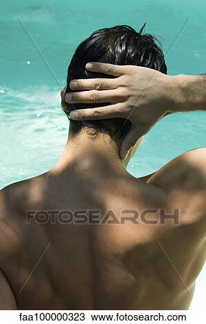 Man touching back of head, pool in background View Large Photo Image Stock Image - Man touching back of head, pool in background. Fotosearch