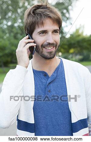 Stock Photo - Man using smartphone outdoors. Fotosearch