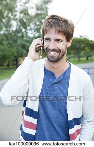 Stock Photograph - Man using smartphone outdoors. Fotosearch