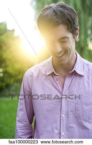 Man walking in park View Large Photo Image Stock Image - Man walking in park. Fotosearch