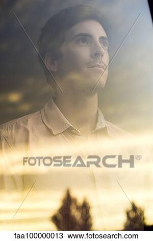 Man watching sunrise with optimstic outlook View Large Photo Image Stock Image - Man watching sunrise with optimstic outlook. Fotosearch