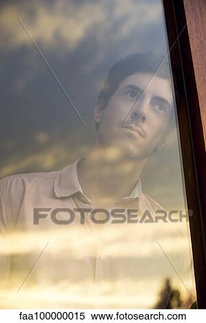 Man watching sunset from window View Large Photo Image Stock Photography - Man watching sunset from window. Fotosearch